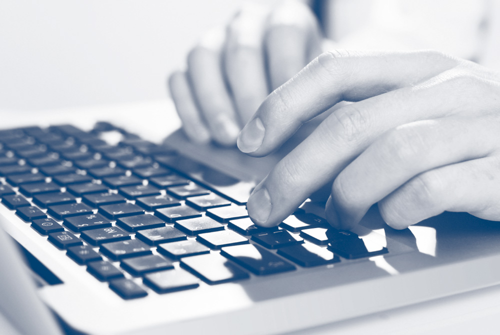 hands typing on a keyboard