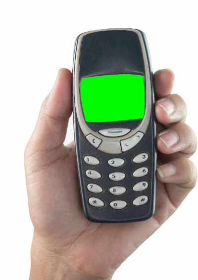 A person holds a Nokia 3210 in the palm of their hand.