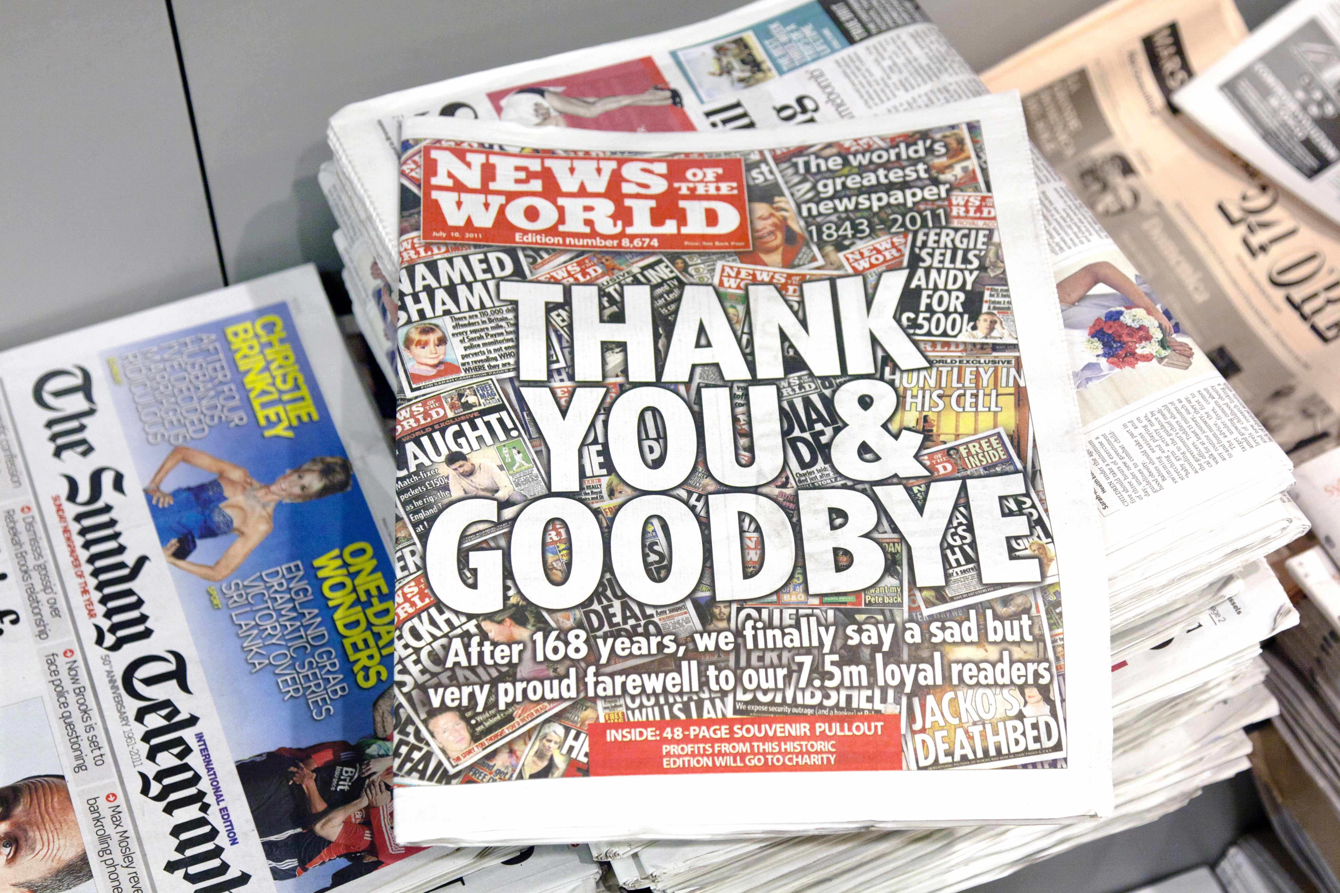 A pile of newspapers. On the top of the pile is edition number 8674 of the News of the World. The front page reads “Thank you and Goodbye”. This is the last ever edition of the News of the World. At the top of the page you can see that the news of the world existed from 1843 to 2011. 